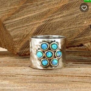 Carved silver and turquoise colored stone ring.  Size 10